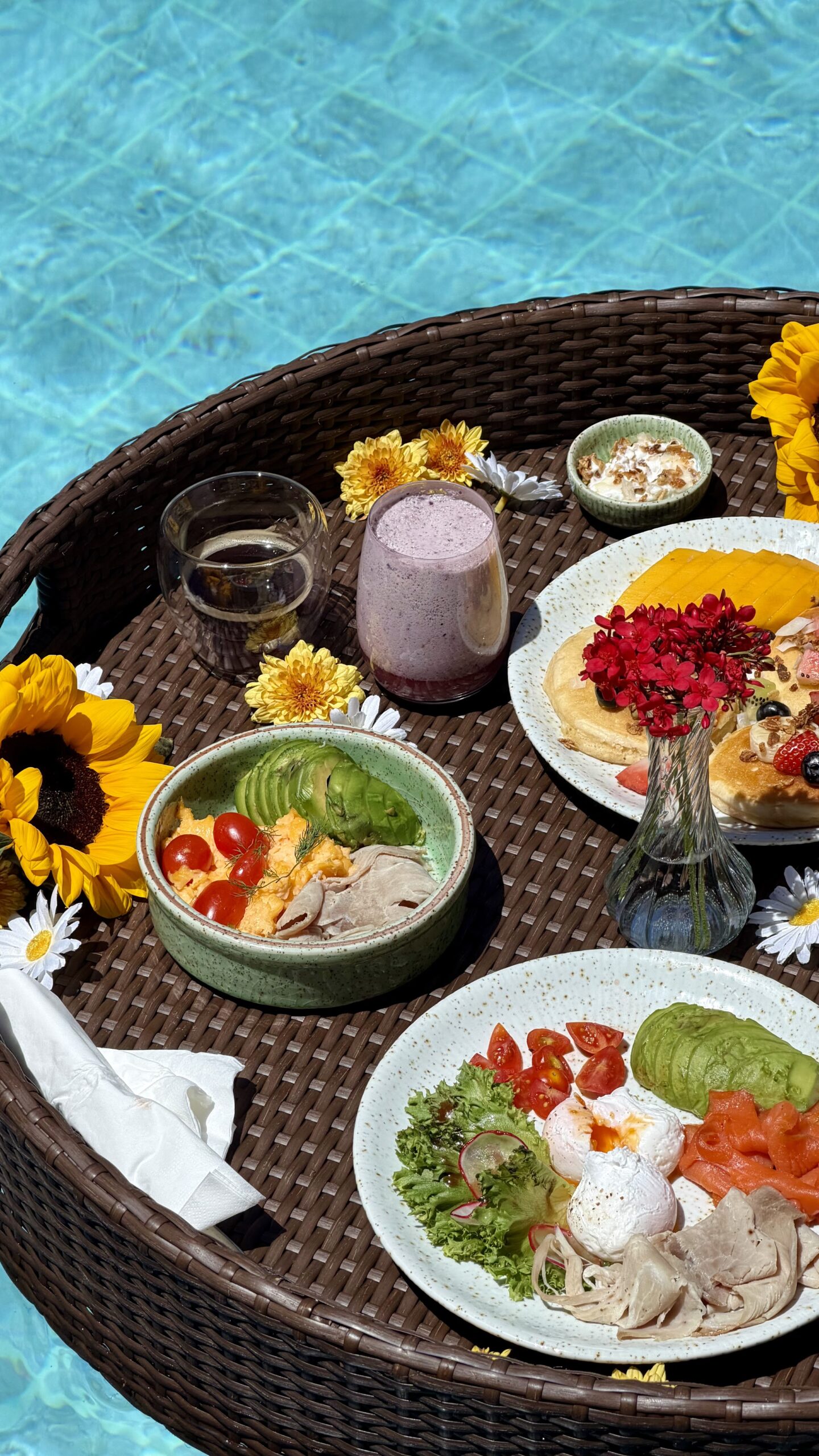 Overhead view of a floating breakfast tray in a villa pool in Phuket