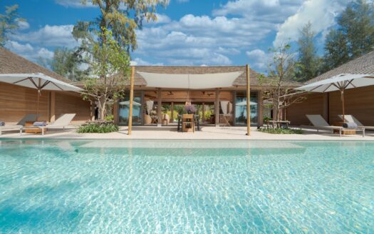 The pool and pavilions at Villa Pinara seen across the water
